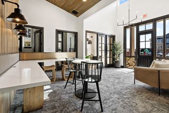 a living room with a table and chairs and a kitchen